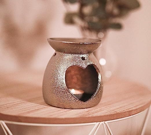 Love heart candle burner on a wooden table
