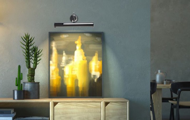 Picture wall lights, paired with a yellow pixel painting sat on a table with plants next to it