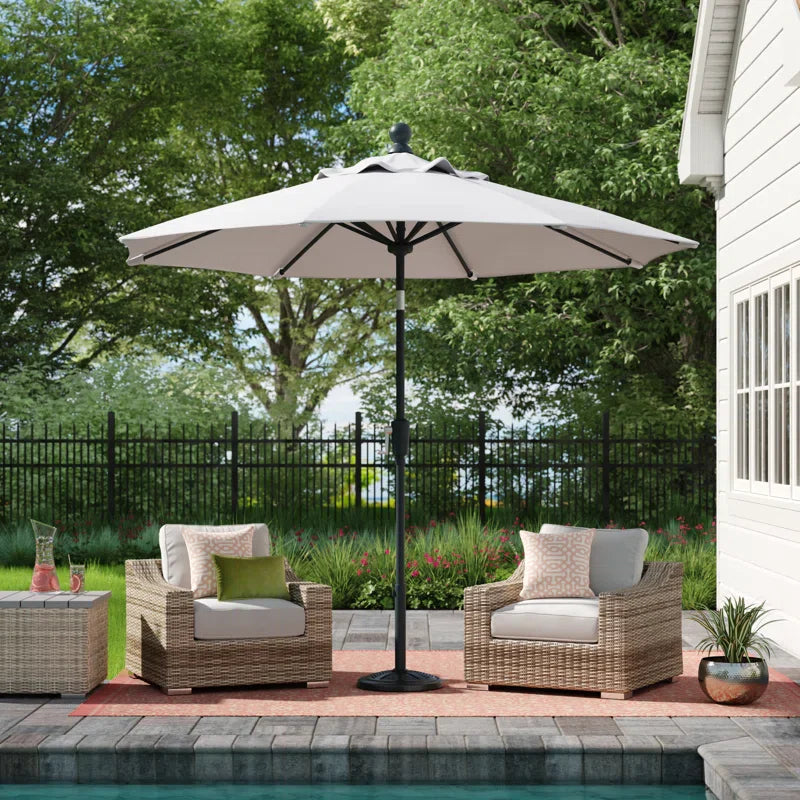 Cream parasol next to a pool and garden furniture