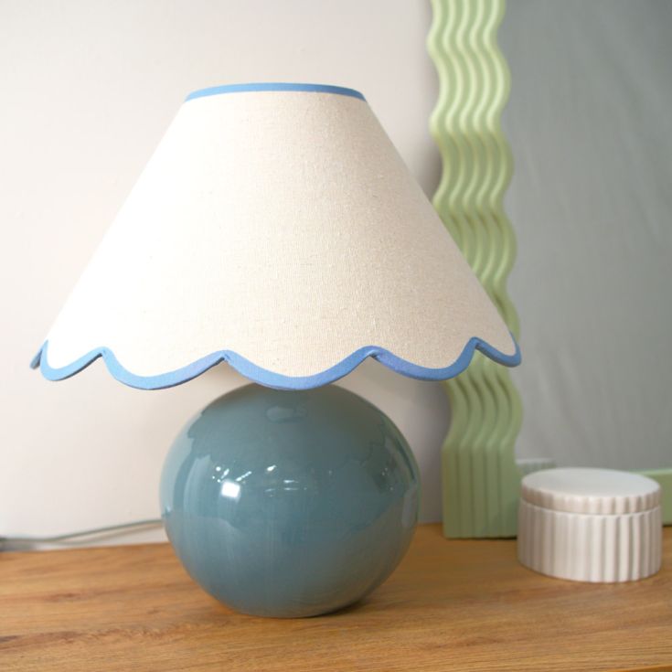 Light shade with scallop detailing on a blue circle lamp base