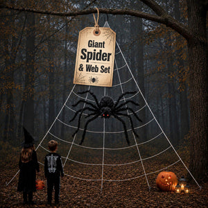 Halloween decoration set in a forest featuring a large white spider web frame, a giant black spider hanging from a branch, a sign that reads 'Giant Spider & Web Set', and two children in witch attire looking at the display.