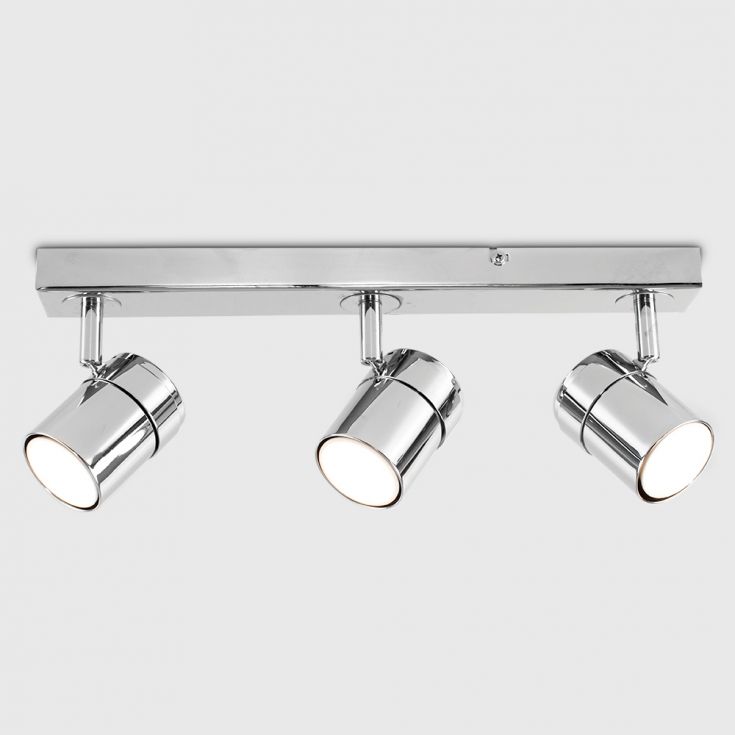 Modern ceiling light fixture with three spotlights on a neutral background