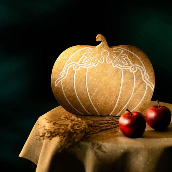 Decorative pumpkin with intricate carvings on a dark background