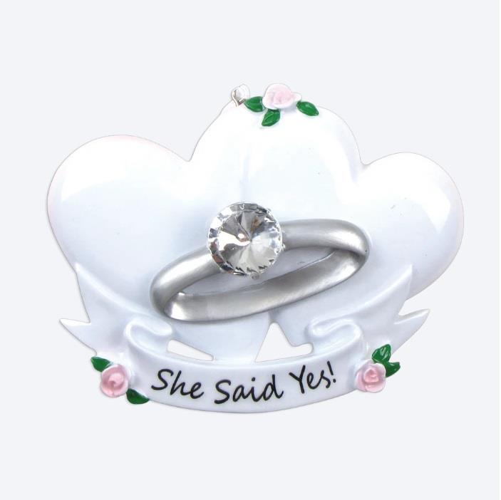 Ring holder with 'She Said Yes!' text on a white background