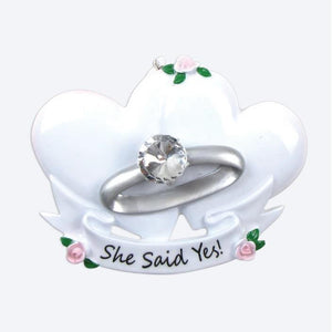 Ring holder with 'She Said Yes!' text on a white background