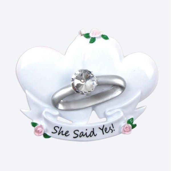 Ring holder with 'She Said Yes!' text on a white background