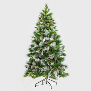 Snow effect festive tree displayed in a living room