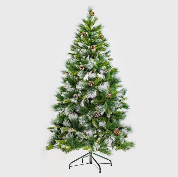 Snow effect festive tree displayed in a living room