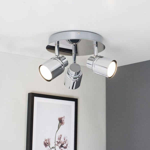 Ceiling light fixture with three lights on a white ceiling