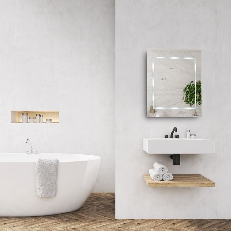 Modern bathroom with a freestanding bathtub, sink, and mirror.