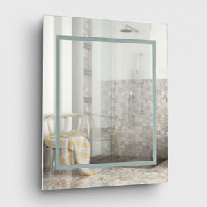 Rectangular mirror with a decorative frame on a white wall