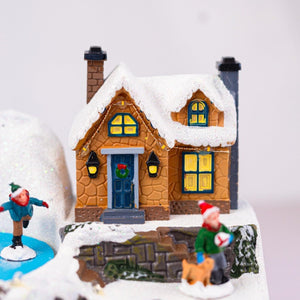 Traditional Christmas village scene with decorative ice rink