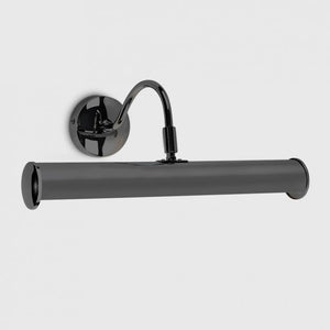 Black wall-mounted lamp with cylindrical shade on a light gray background