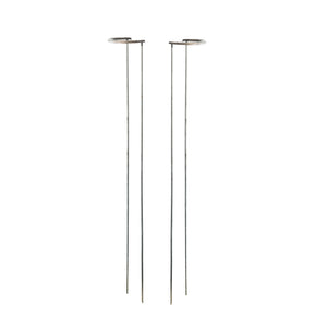 Two modern minimalist floor lamps with thin metal stands and circular disc shades, shown on a plain white background.