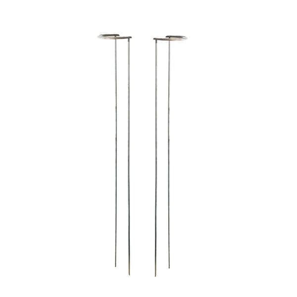 Two modern minimalist floor lamps with thin metal stands and circular disc shades, shown on a plain white background.