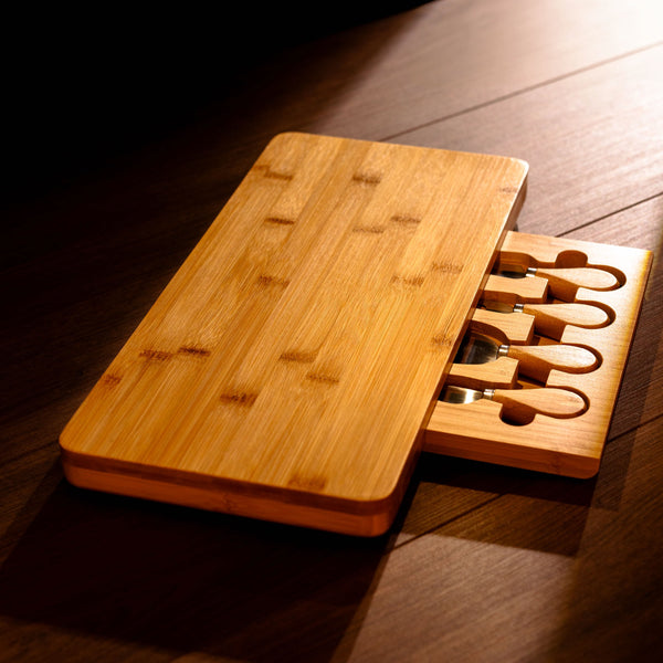 Wooden cutting board with knife sharpener on a wooden surface