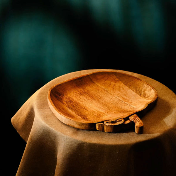 Wooden bowl with handles on a dark background