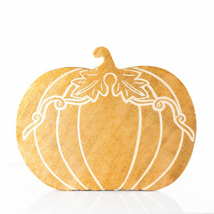 Decorative pumpkin-shaped cutting board with white lines on a white background
