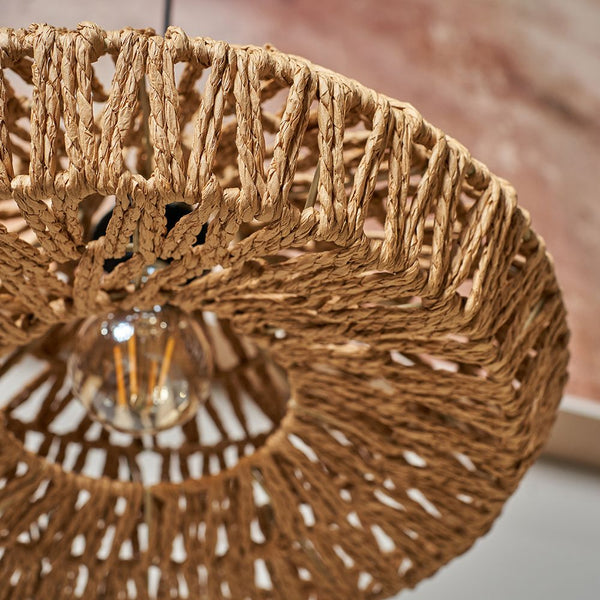 Close-up of a woven rattan lampshade with a blurred background