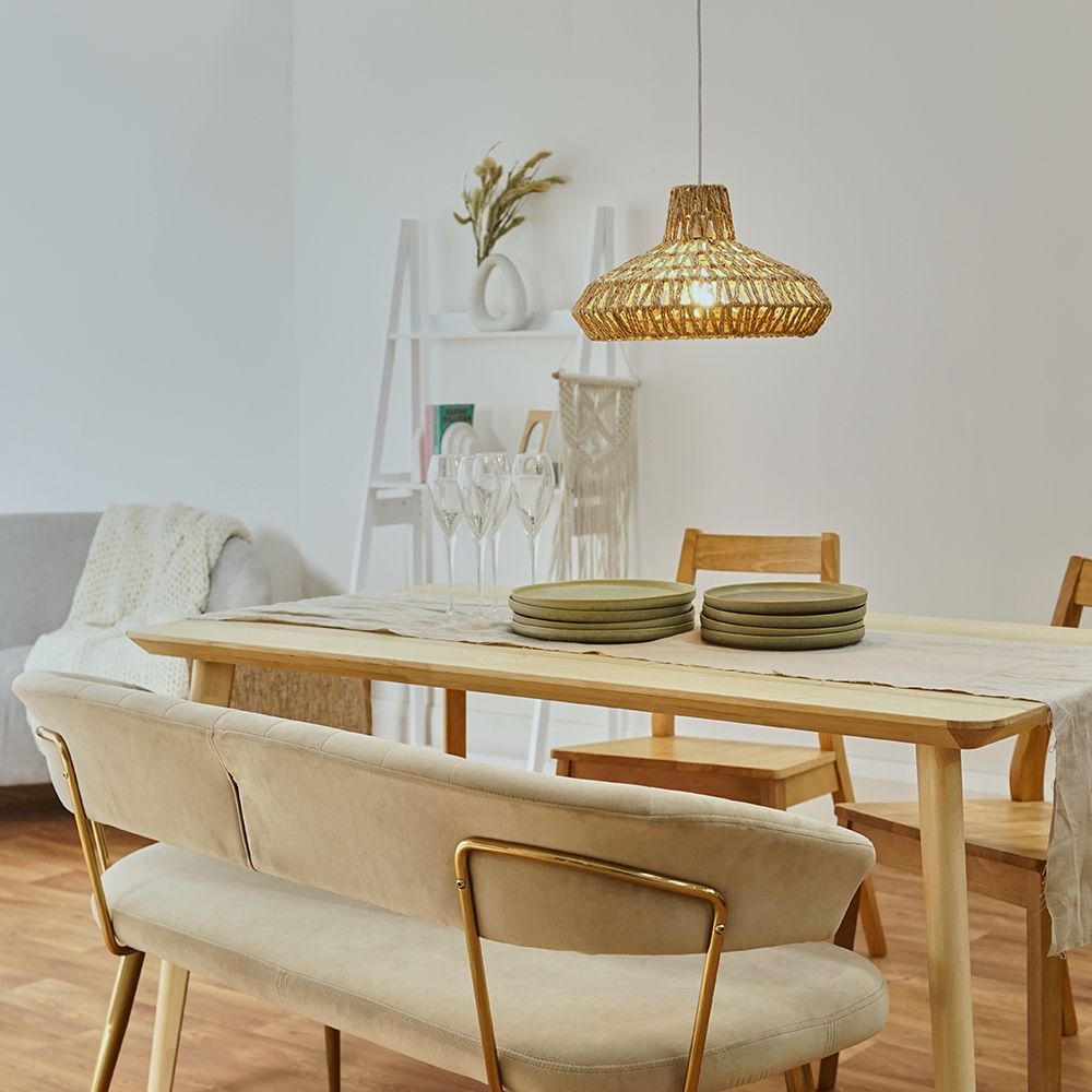 Dining room with wooden table, chairs, and a wicker pendant light.