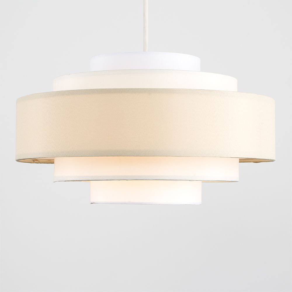 Modern pendant light with white fabric shade on a plain background