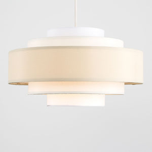 Modern pendant light with white fabric shade on a plain background