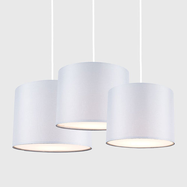 Three white pendant lights on a white background
