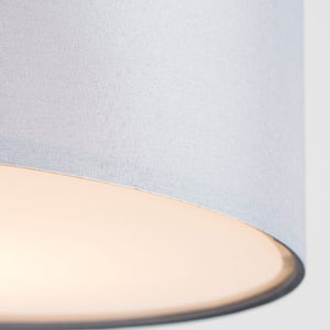 Close-up of a light blue fabric with a beige border on a white background