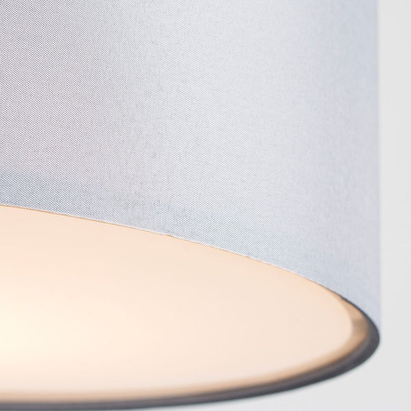 Close-up of a light blue fabric with a beige border on a white background