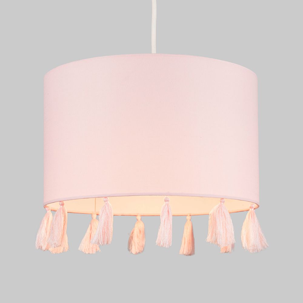 Pink lampshade with tassels on a gray background