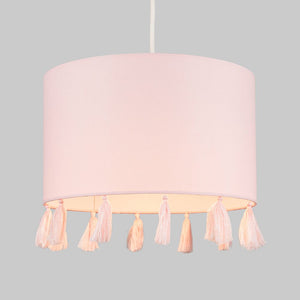 Pink lampshade with tassels on a gray background