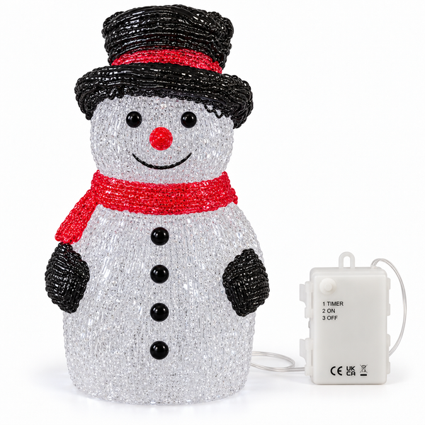 A snowman-shaped Christmas light decoration made of silver glitter beads, with a black beaded top hat, red beaded scarf and nose, black beaded hands and buttons, and a white plastic control box shown beside it on a white background.