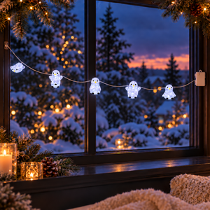Glowing white penguin-shaped string lights hanging across a window, with a snowy winter forest and warm sunset lights in the background.
