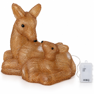 A textured golden-brown deer and baby deer figurine with small black eyes, shown on a white background with a small white power adapter and wire.