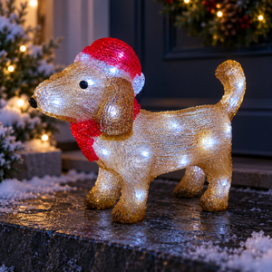 Illuminated acrylic dachshund wearing a red Santa hat and scarf on a snowy door entrance, with cool white LEDs and festive lights behind.