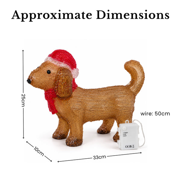 acrylic dachshund wearing a red Santa hat and scarf on white background