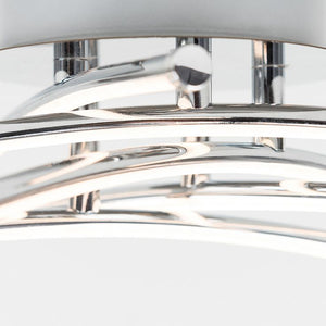 Close-up of a modern ceiling light fixture with chrome finish