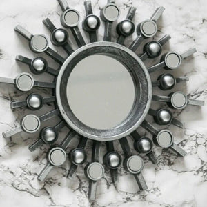 Silver sunburst mirror set shown on feature wall