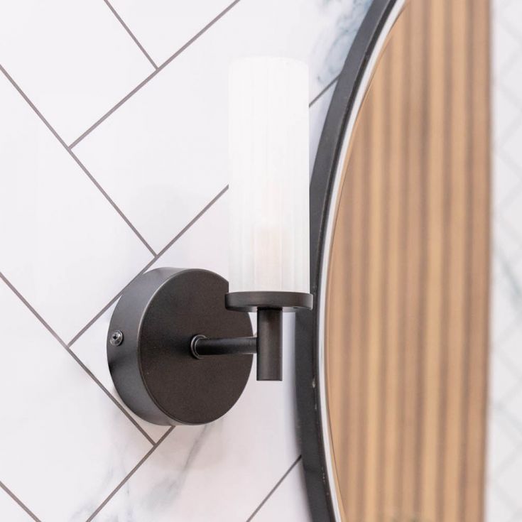 Round wall light fixture on a tiled wall