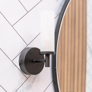 Round wall light fixture on a tiled wall