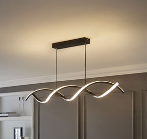 Modern pendant light fixture hanging in a room with neutral walls.