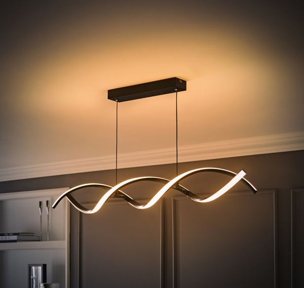 Modern ceiling light fixture with wavy design in a room setting