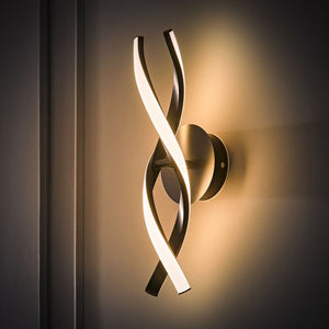 Modern wall light fixture with curved design on a dark background