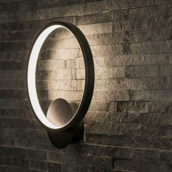 Round wall-mounted light fixture on a stone wall