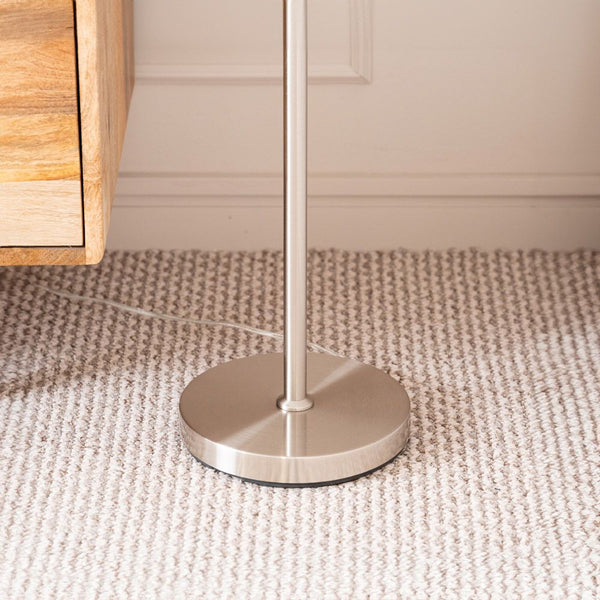 Silver stand on a textured beige carpet