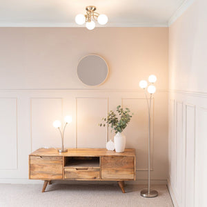 Modern living room with wooden TV stand, decorative items, and wall lights.