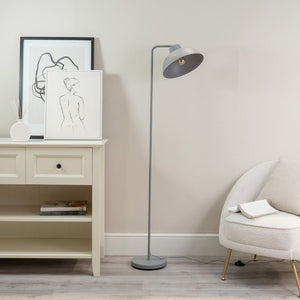 Modern interior with a floor lamp, white cabinet, and armchair.