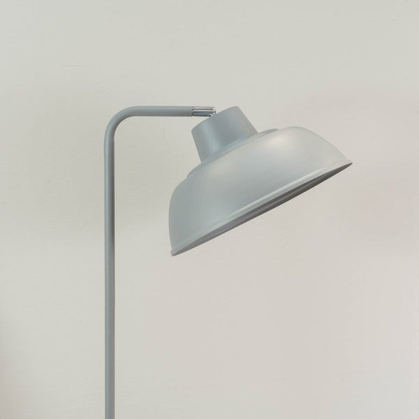 Gray floor lamp against a plain background