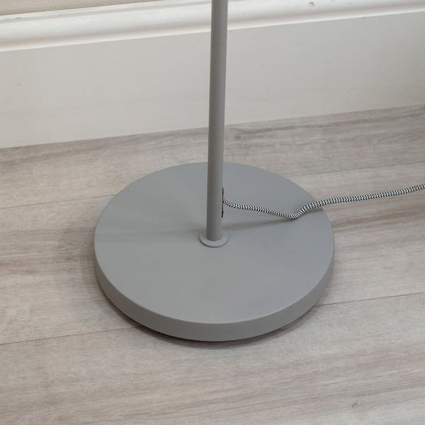 Gray floor lamp base on a wooden floor