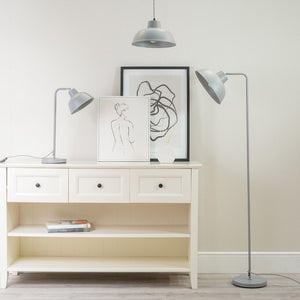White bookshelf with decorative items and floor lamps in a room.